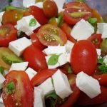 Tomate cereja com queijo e mangericão